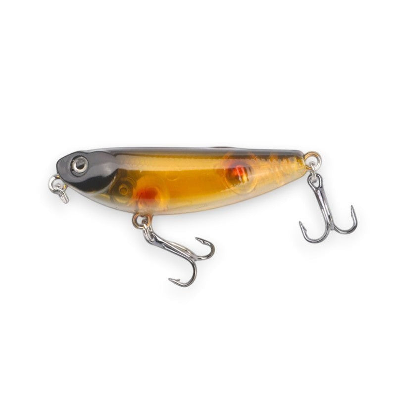 WBQ Tackle supplies Superse MicroZig WTD PE024 fishing lure, transparent amber body with black head and red accents, features two treble hooks.
