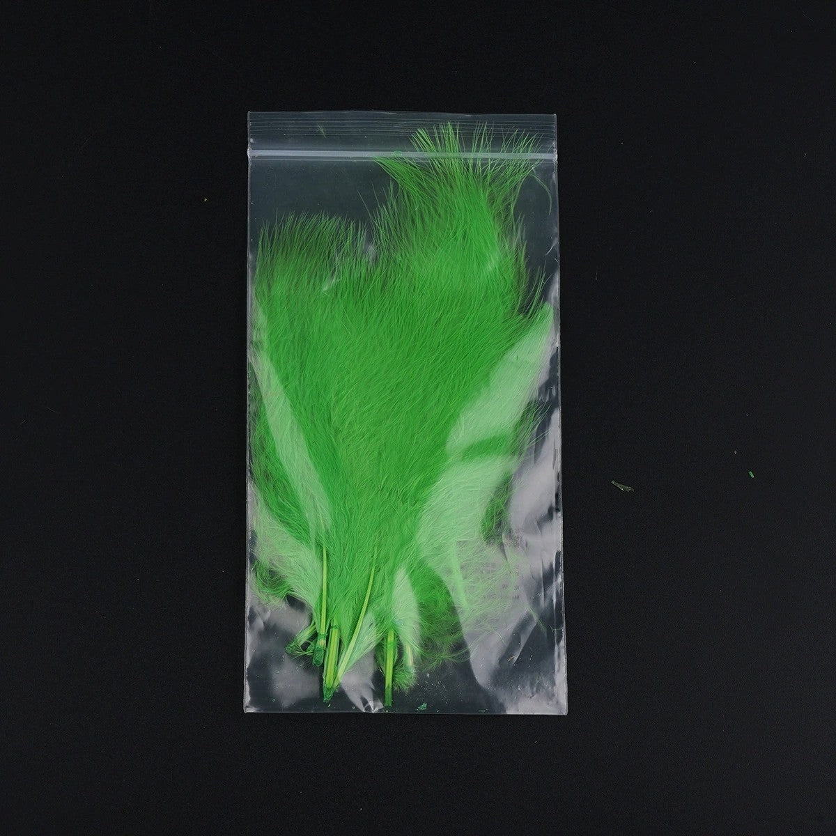 WBQ Tackle supplies bright green marabou feathers for fly tying, packaged in a clear plastic bag.