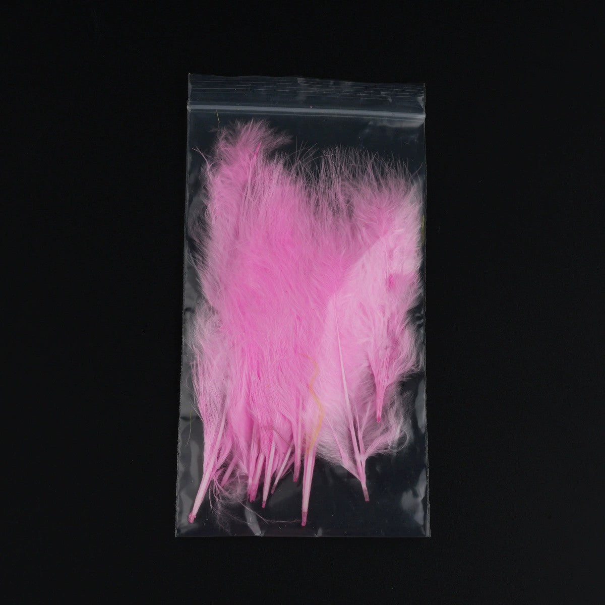 WBQ Tackle supplies Superse Marabou fly tying feathers in bright pink, packaged in a clear plastic bag.