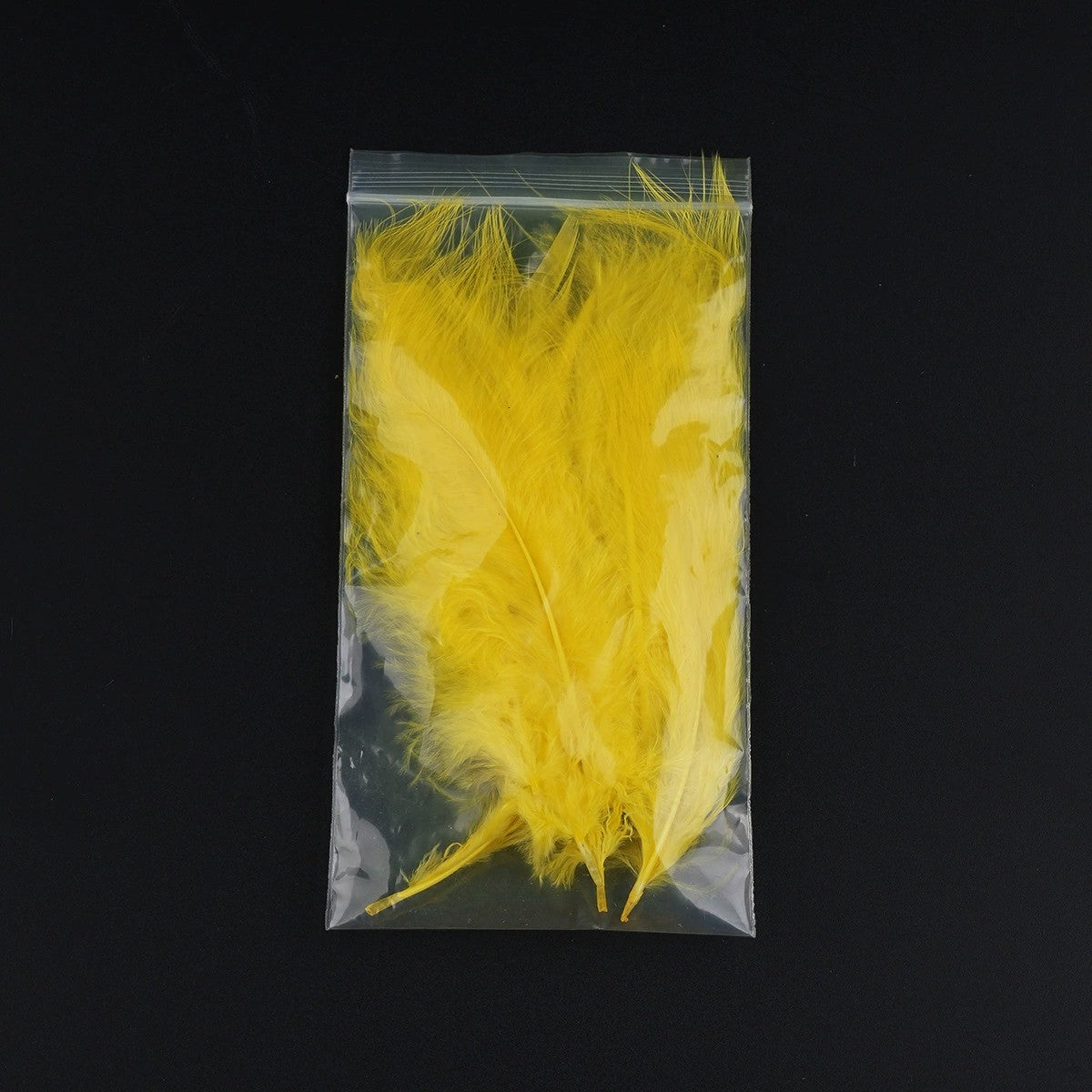 WBQ Tackle supplies Superse MARABOU fly tying feathers in bright yellow, packaged in a clear plastic bag.