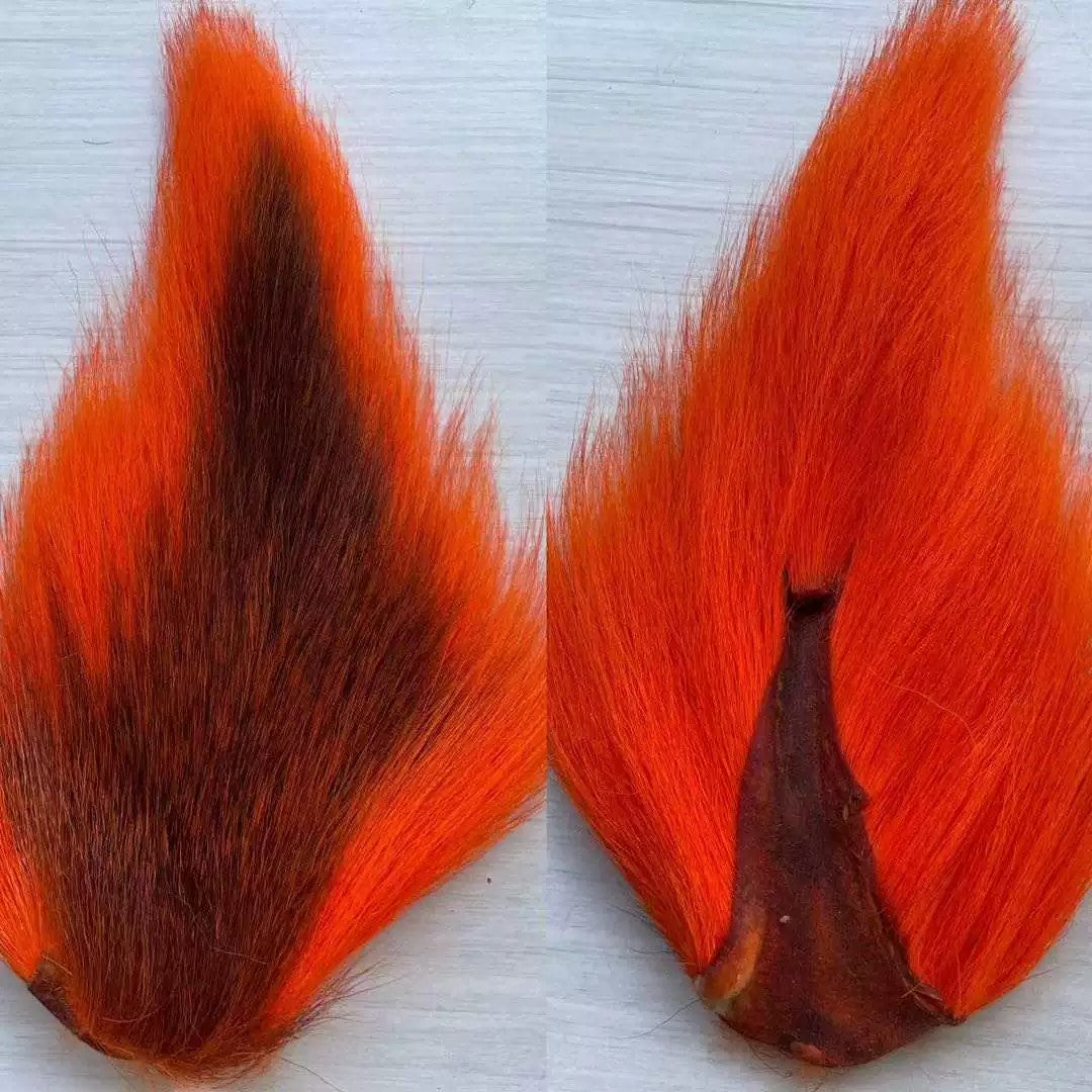 WBQ Tackle supplies bright orange bucktail fur with a dark brown center, ideal for fly tying.