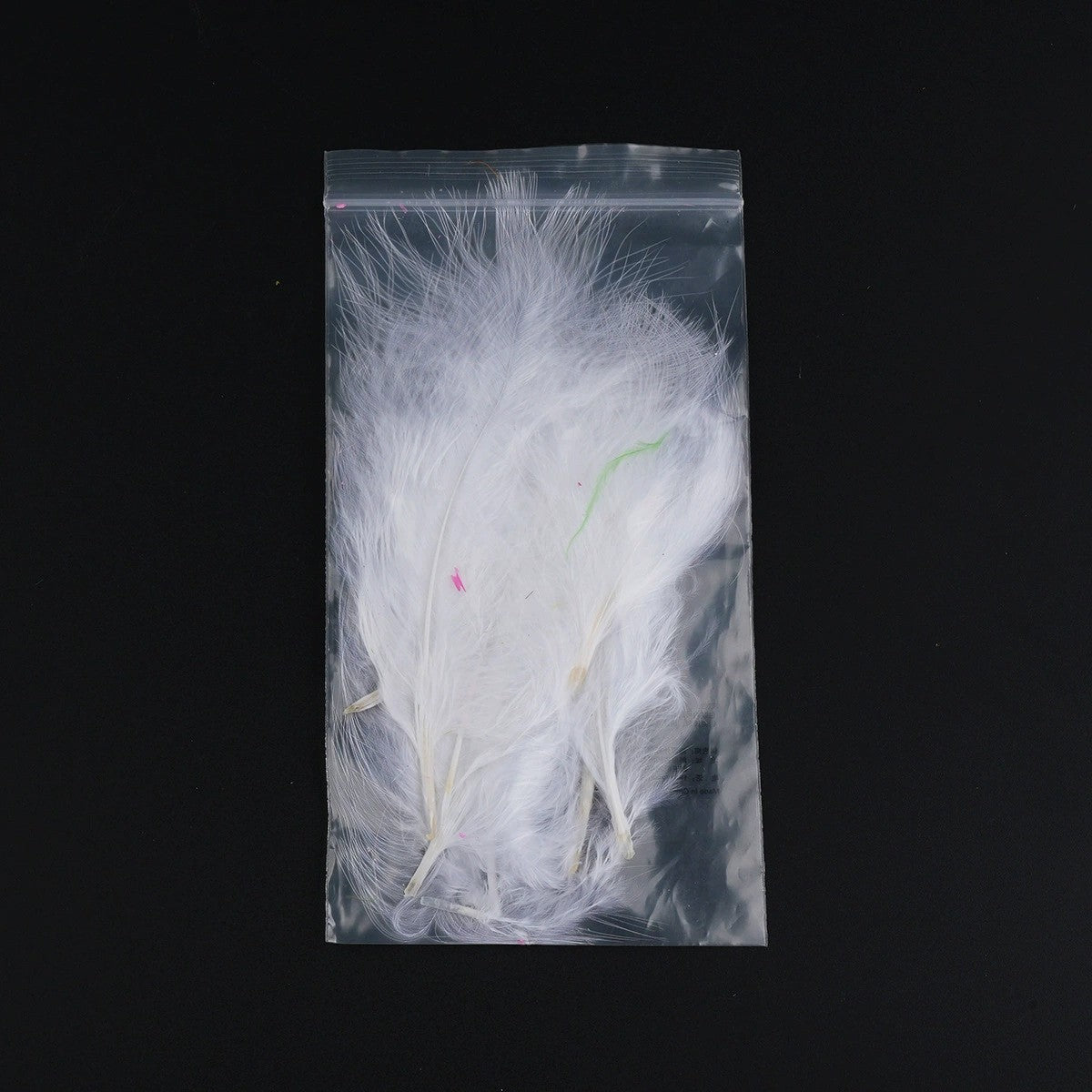 WBQ Tackle supplies white marabou feathers for fly tying, with hints of pink and green.